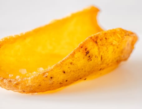 Golden dipper rests alone in focus, edges crisp and texture richly detailed