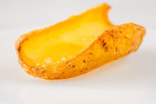 Golden dipper rests alone in focus, edges crisp and texture richly detailed