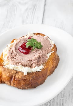 Toasted wheat sandwich with pate, creamy cheese, and tart cranberry jam