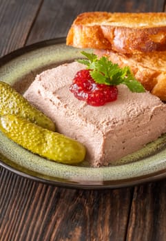 Lush pate paired with tart jam, crispy toast, and briny pickled vegetables