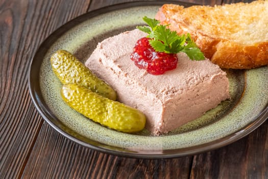 Lush pate paired with tart jam, crispy toast, and briny pickled vegetables