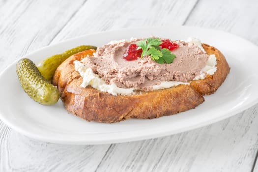 Toasted wheat sandwich with pate, creamy cheese, and tart cranberry jam