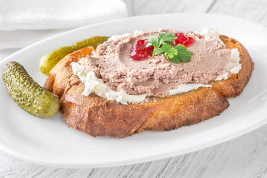 Toasted wheat sandwich with pate, creamy cheese, and tart cranberry jam
