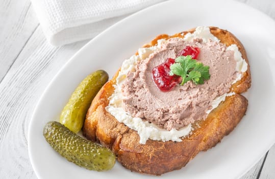 Toasted wheat sandwich with pate, creamy cheese, and tart cranberry jam