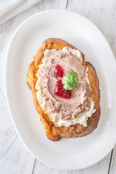 Toasted wheat sandwich with pate, creamy cheese, and tart cranberry jam