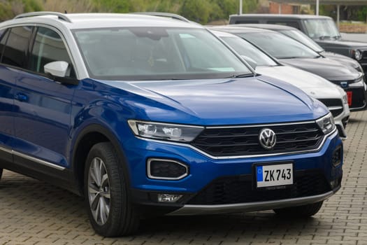Gaziveren Cyprus -10.04.2025 A striking blue compact SUV sits proudly among various other vehicles in a car lot. The overcast sky adds a serene ambiance, inviting potential buyers to admire its sleek lines and features.