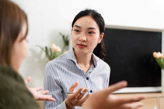 The psychiatrist facilitates an in-depth conversation with a client, focusing on personal insights and emotional well-being in a supportive atmosphere.
