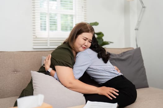 During a therapy session, a poignant moment occurs as a psychiatrist hugs her client, reinforcing the bond of trust and emotional support.