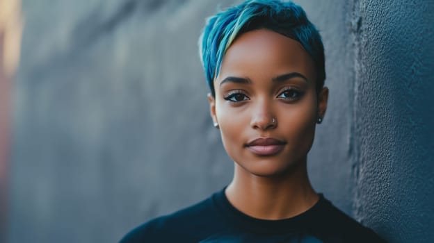 Portrait of stylish young African woman with blue dyed hair, beautiful black girl standing on a city street, looking at camera