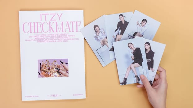 Gatineau, QC Canada - 03.16.2024: K-pop group Itzy Guess Who music Album on yellow background. Special edition music CD. South Korean girl group Itzy