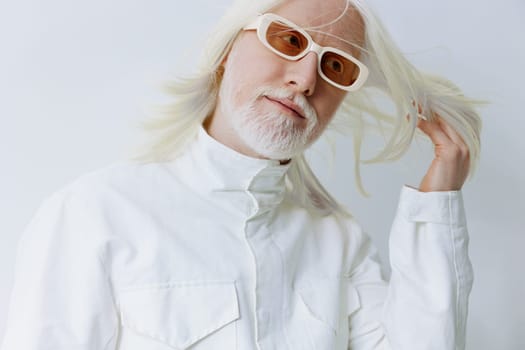 This image depicts a fashionable elderly man with long white hair and stylish glasses, set against a clean white background The scene emphasizes modern style and self expression, combining elegance and contemporary fashion trends