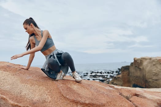 Athletic woman in trendy sportswear enjoys the beach, promoting health and wellness with a tranquil ocean view A perfect representation of fitness and nature
