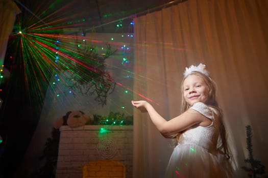 A cheerful child in a festive dress spreads joy among colorful lights and decorations during Christmas celebrations.