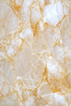 A close-up of a luxurious beige marble background featuring intricate gold veins and subtle cracks, perfect for elegant design, luxury interiors, and abstract patterns.