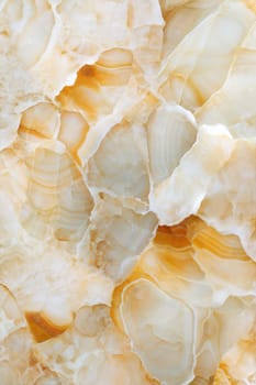 A detailed close-up of a beige marble background with golden veins and smooth texture, creating an elegant and luxurious stone surface ideal for design and decor.