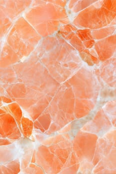 A vibrant orange marble background featuring smooth white and golden veins, perfect for luxury designs, home decor, and modern projects.