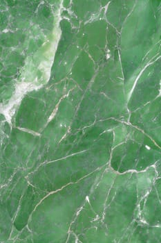 Stunning green marble background featuring intricate cracks and smooth texture. Ideal for design, home decor, and modern projects.