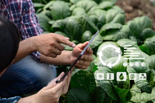 Farmer using digital tablet with futuristic agriculture data in greenhouse, sustainable smart farming concept.