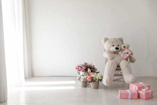 Polar bear toy flower baskets and gifts in the interior of a white room