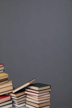 Stacks of old educational books for teaching in the library on a gray background at school university