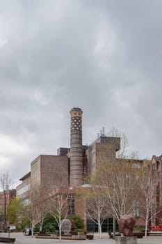 Newcastle, UK - Apr 14, 2025 - Architecture exterior view of The Boiler House and chimney with sky background at Newcastle University. the building housed the Emerson Cavitation Tunnel (propeller testing and hydrodynamics research facility), use it as your Wallpaper, Poster and Space for text, Selective focus.