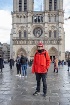 Paris, France - February 22nd 2025 : visitors in The Notre-Dame de Paris, newly re-opened cathedral restored after reconstruction, details of exterior