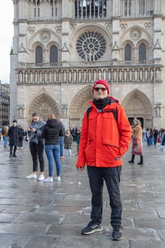 Paris, France - February 22nd 2025 : visitors in The Notre-Dame de Paris, newly re-opened cathedral restored after reconstruction, details of exterior