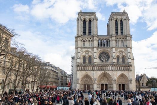 Paris, France - February 22nd 2025 : visitors in The Notre-Dame de Paris, newly re-opened cathedral restored after reconstruction, details of exterior