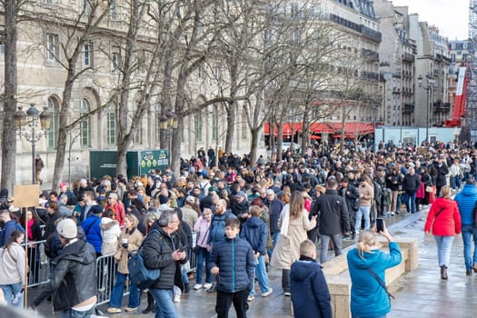 Paris, France - February 22nd 2025 : visitors in The Notre-Dame de Paris, newly re-opened cathedral restored after reconstruction, details of exterior