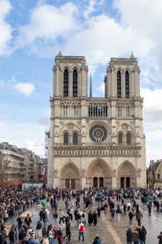Paris, France - February 22nd 2025 : visitors in The Notre-Dame de Paris, newly re-opened cathedral restored after reconstruction, details of exterior