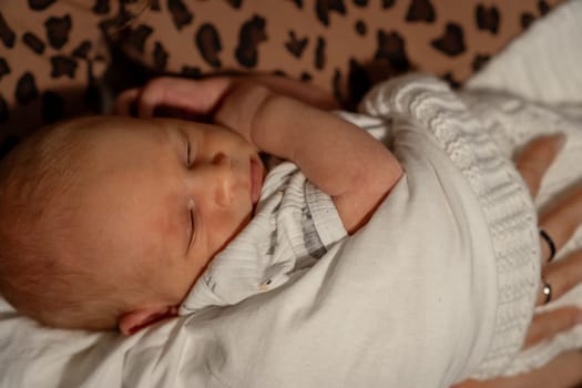 In a warm, comforting environment, a mother peacefully holds her newborn baby, emphasizing the close bond and love shared in this intimate moment.