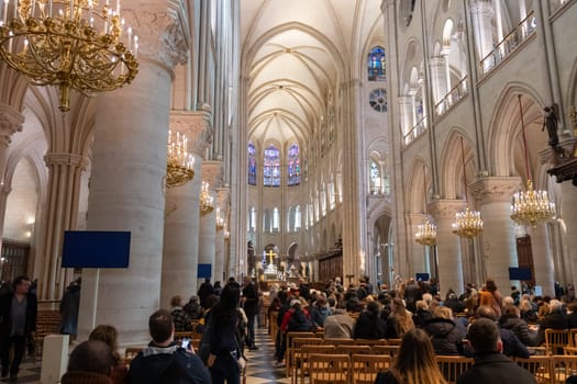 Paris, France - February 22nd 2025 : visitors in The Notre-Dame de Paris, newly re-opened cathedral restored after reconstruction, details of exterior