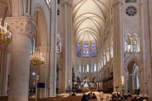 Paris, France - February 22nd 2025 : visitors in The Notre-Dame de Paris, newly re-opened cathedral restored after reconstruction, details of exterior