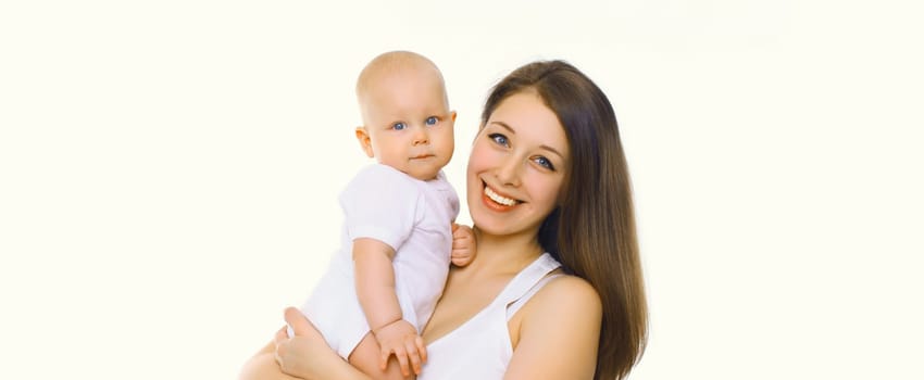 Portrait of happy cheerful smiling mother holding her baby, joyful young mom and little child on white studio background