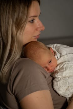 A loving mother cradles her newborn baby in a soothing atmosphere, reflecting tenderness and connection between them as they share a peaceful moment.