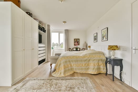 A stylish and cozy modern bedroom featuring a neatly made bed, elegant decor, and ample natural light illuminating the space.