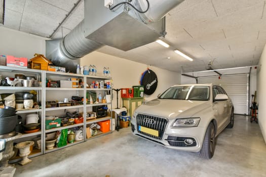 A well-lit garage showcasing a silver SUV parked next to shelves holding various organized tools and equipment, emphasizing functionality and space.