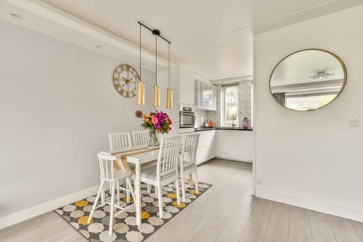 A sleek, modern dining space featuring a stylish table set, vibrant flowers, and elegant lighting, complemented by a minimalist aesthetic and a warm atmosphere.