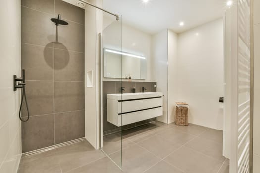 Contemporary bathroom featuring sleek shower area, minimalist fixtures, and stylish cabinetry for a functional and elegant space.