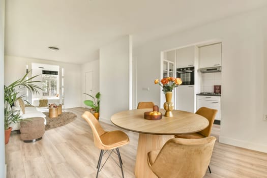 A stylish and contemporary living room featuring open spaces, chic furniture, and vibrant plants, perfect for relaxation and social gatherings.