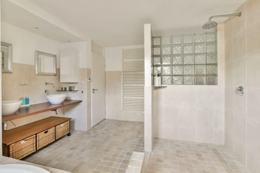 Contemporary bathroom showcasing minimalist design with elegant fixtures and natural light. Features a spacious shower and storage solutions.