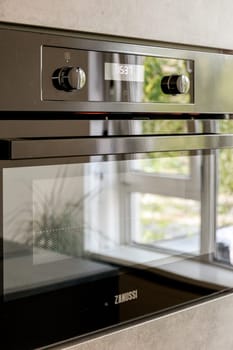 A sleek and stylish Zanussi built-in oven with digital display and control knobs, perfect for any contemporary kitchen aesthetic.