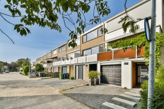 A street view showcasing modern residential buildings with greenery and well-maintained sidewalks, reflecting urban living aesthetics.