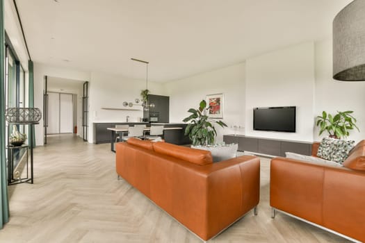 Contemporary living room showcasing minimalist furniture, elegant lighting, and an open layout, enhancing comfort and style in a cozy space.