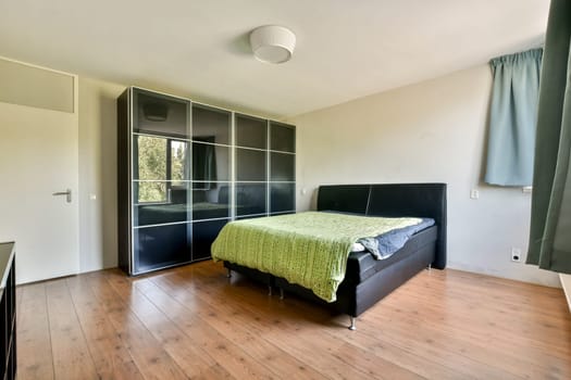 A contemporary bedroom featuring sleek furniture, a large window for natural light, and a minimalist aesthetic that promotes relaxation and tranquility.