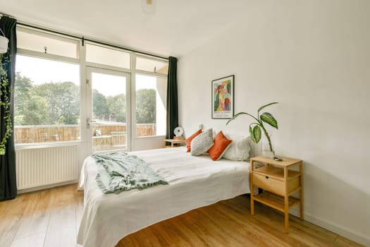 A bright and inviting modern bedroom featuring a comfy bed, natural light, and stylish decor elements, perfect for relaxation and comfort.