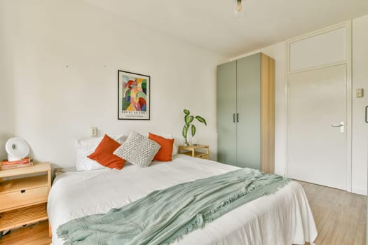 A serene and stylish modern bedroom featuring a minimalistic design, fresh linens, and a touch of greenery, ideal for relaxation and comfort in a contemporary setting.