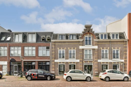 Charming street scene featuring classic buildings with intricate designs and parked cars, showcasing a blend of urban life and historic aesthetics.