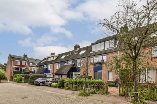 A serene view of a picturesque residential street featuring charming houses surrounded by greenery, creating a peaceful neighborhood atmosphere.