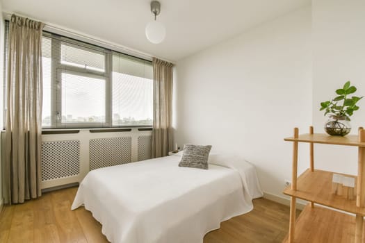 A serene and airy minimalist bedroom featuring a simple bed, wooden accents, and plants, promoting relaxation and comfort.